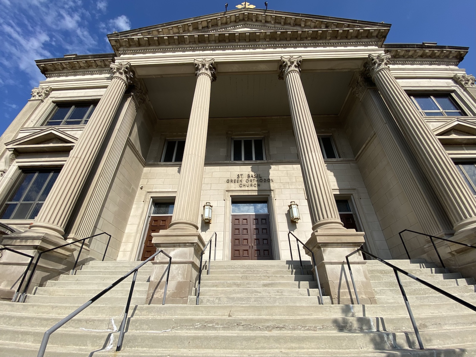 Entrance with staircase that leads to St. Basil Greek Orthodox Church, a greek revival style structure.